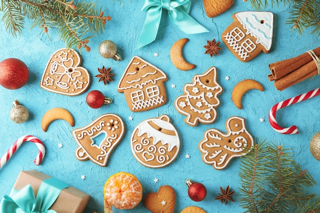 Flat lay composition with tasty homemade Christmas cookies, on blue. Top view