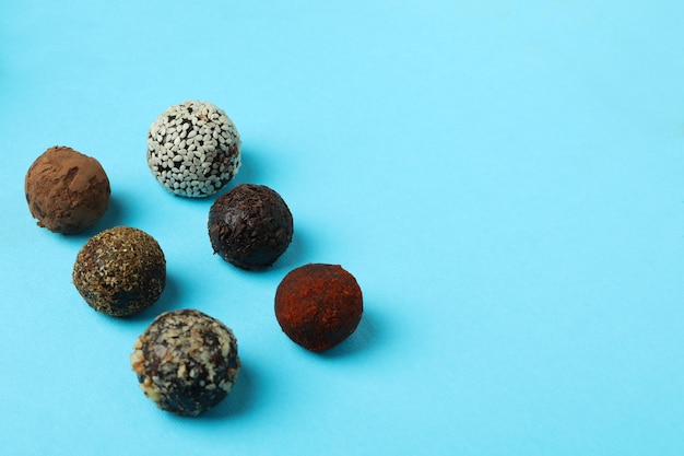 Flat lay composition with truffles on blue background