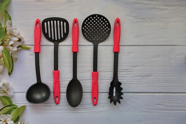 Flat lay of cooking tools and kitchen utensils on wooden background