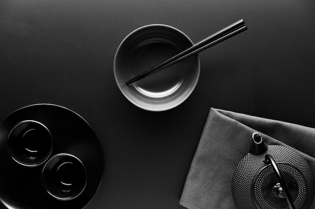 Photo flat lay of crockery with teapot and chopsticks