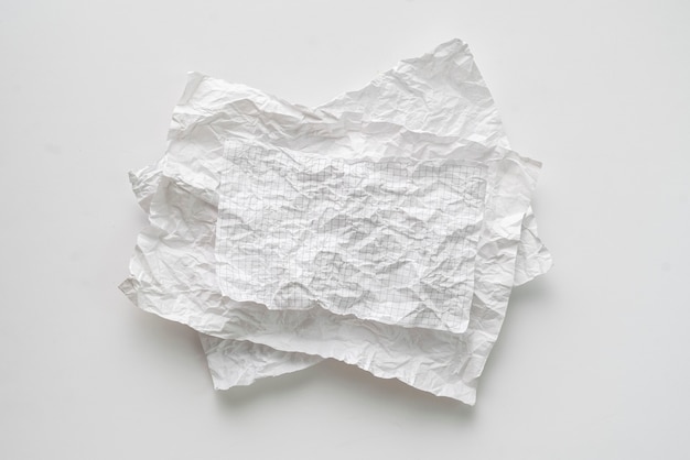 Flat lay crumpled white paper sheet isolated on the table, background texture 