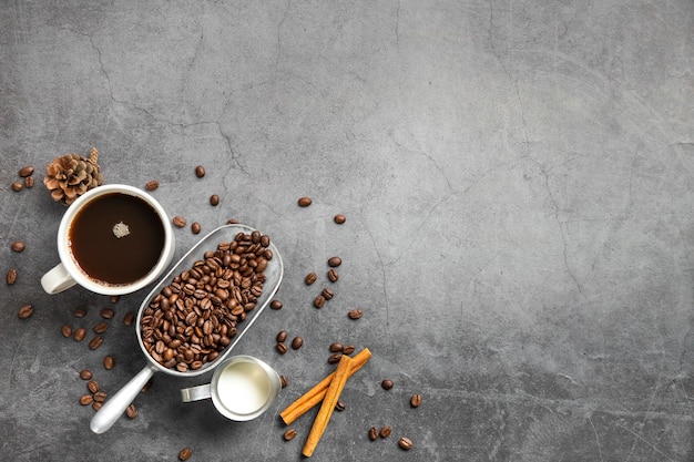 Flat lay cup of coffee and ingredients with copy space