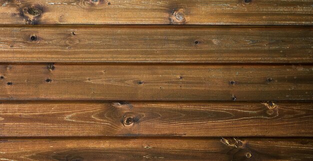 Flat lay dark textured wooden background made of horizontal brown boards Space for text