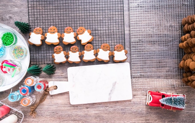 Flat lay. Decorating gingerbread cookies with royal icing.