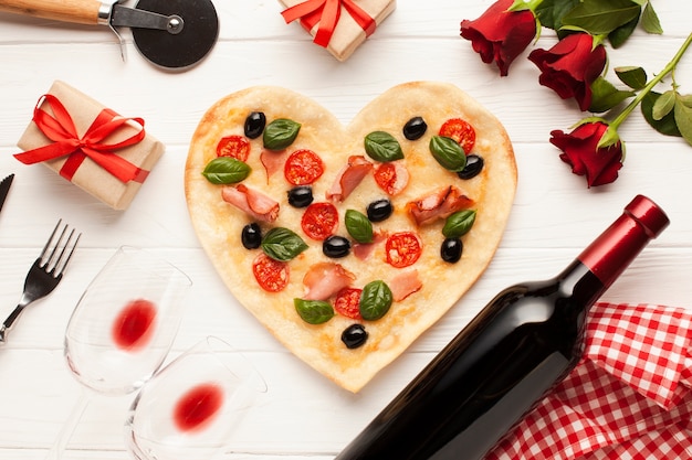 Flat lay decoration with pizza and roses