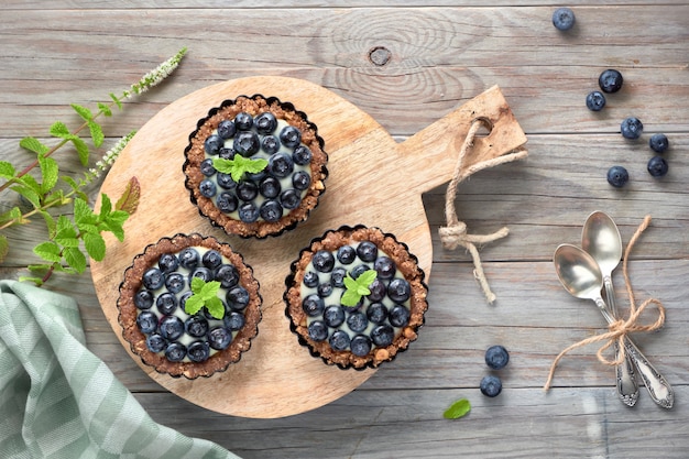 Flat lay of delicious Blueberry tartlets with vanilla custard