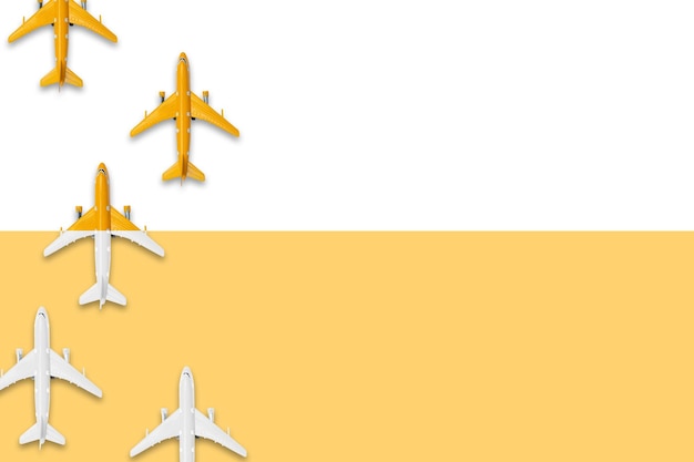 Flat lay design of travel in summer concept Top view of an airplane on blank white and yellow pastel color screen with copy space travel on summer trip