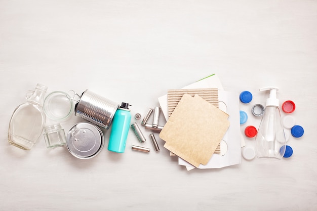 Flat lay of different wastes wastes ready for recycling. plastic, glass, paper, tin cans