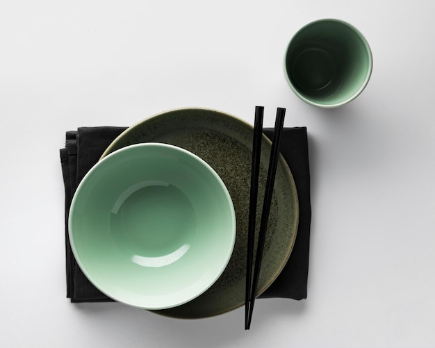 Flat lay of dinnerware with bowl and chopsticks