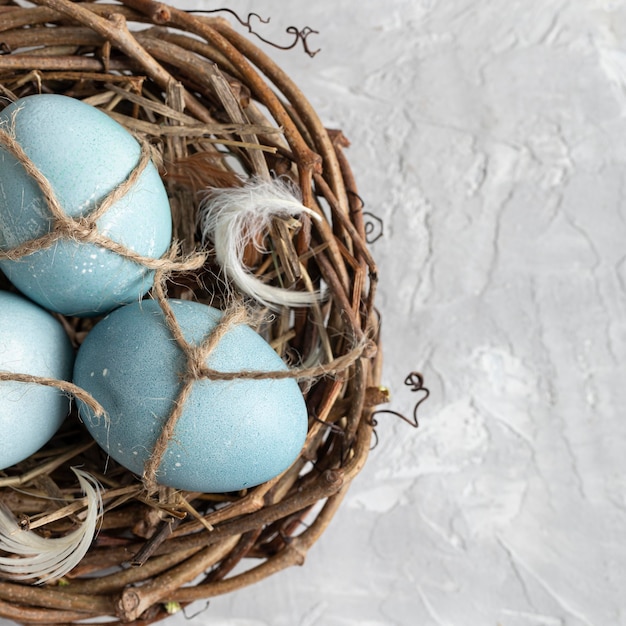 Flat lay of easter eggs in bird nest