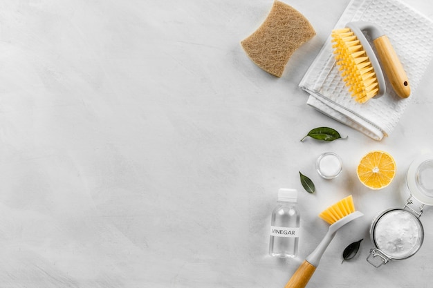 Flat lay of eco-friendly cleaning products collection with brushes and copy space