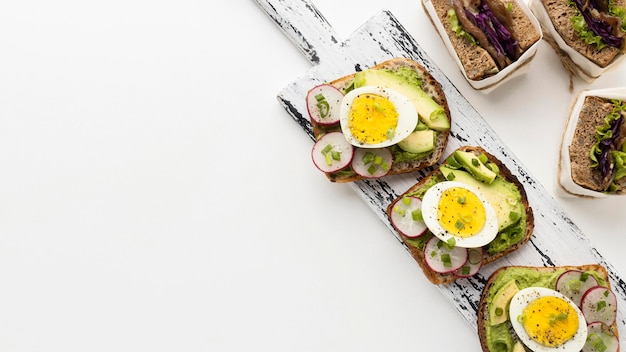 Flat lay of egg and avocado sandwiches with copy space