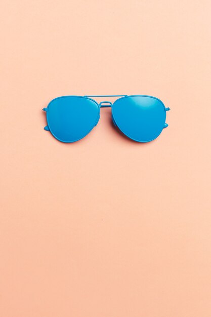 Flat lay fashion set: sunglasses on pastels. 