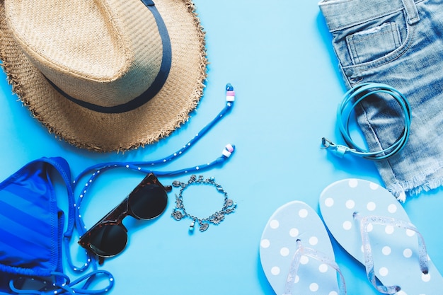 Flat lay of female asccessories on blue background, Spring and summer fashion concept