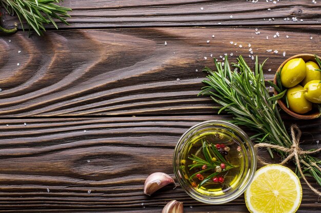 Flat lay food background made of oils condiments and spices on kitchen table. Cooking concept