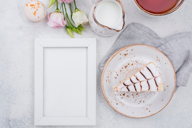 Flat lay of frame with cake and roses