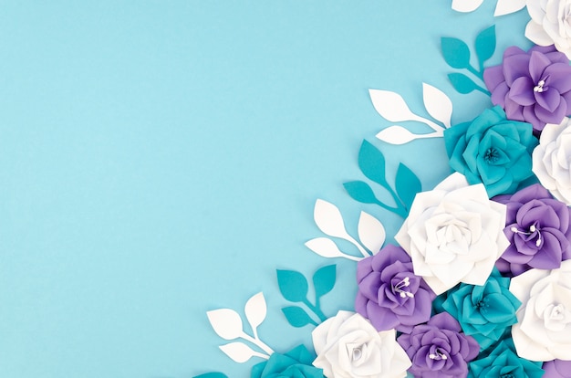 Flat lay frame with flowers and blue background