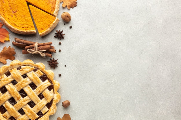 Photo flat lay frame with sliced pumpkin pie and acorn