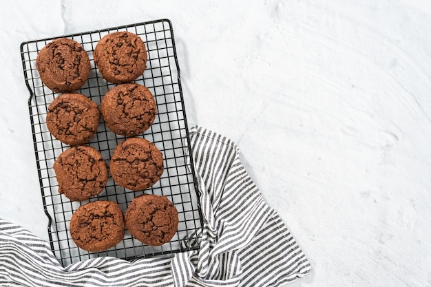 Flat lay. Freshly baked double chocolate chip cookies on a cooling rack.