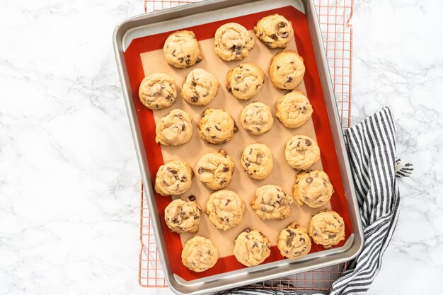 Flat lay. Freshly baked homemade soft chocolate chip cookies on a baking sheet.