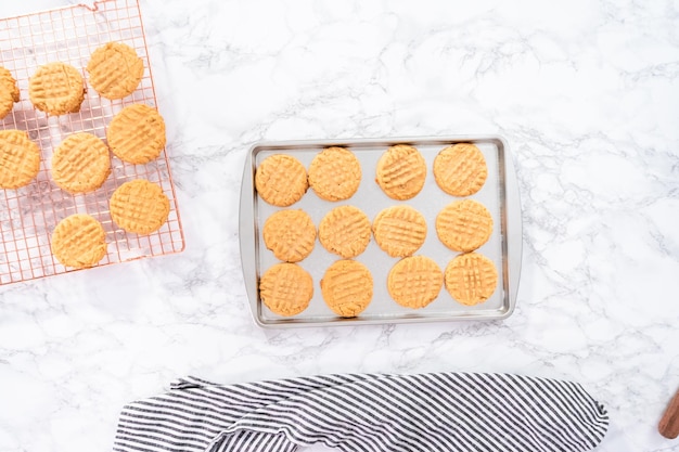 Flat lay. Freshly baked peanut butter cookies on a baking sheet.