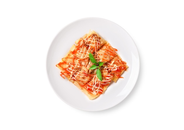 Flat lay of Fried Thai pancake roti with tuna, onion, tomato, ketchup on a plate on white background