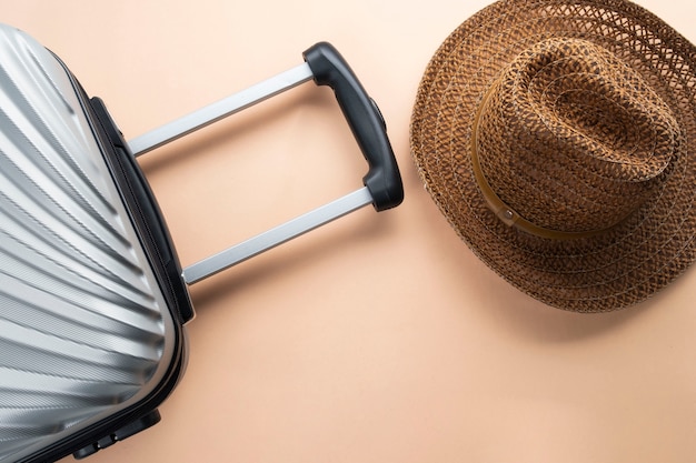 Flat lay grey suitcase with brown hat. travel concept