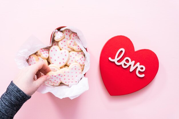 Photo flat lay. heart shaped sugar cookies decorated with royal icing in gift box.