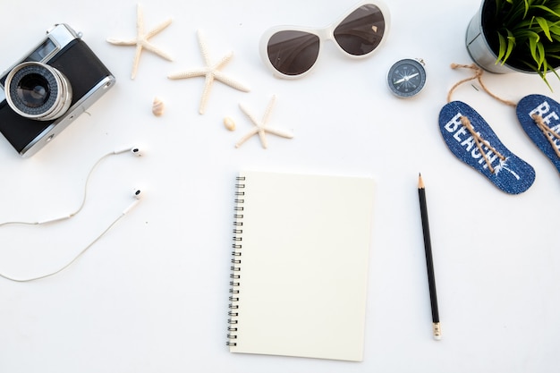 Flat lay holiday concept with retro film camera sunglasses and compass