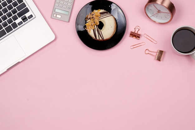 Flat lay home office desk workspace on pink background. Top view.