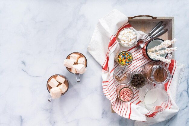 Flat lay. Hot chocolate bar with variety of topping on the tray .