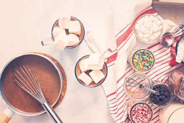 Flat lay. Hot chocolate bar with variety of topping on the tray .