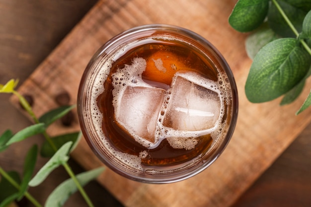 Flat lay iced coffee on wooden board