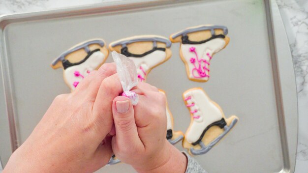 Flat lay. icing figure skate shaped sugar cookies with royal icing