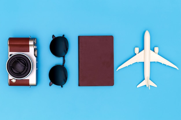 Photo flat lay image of accessory clothing to plan travel in holiday on blue background