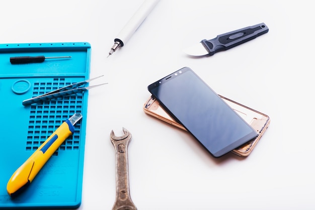 Flat lay image of dismantling the broken smart phone for preparing to repair or replace some components Top view