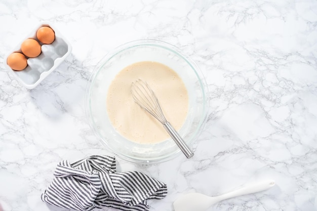 Flat lay. Ingredients for making crepes on a marble countertop.