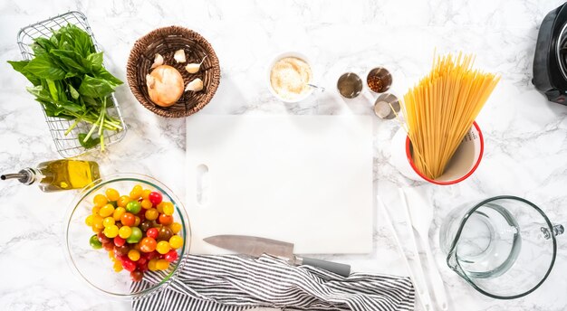 Flat lay. Ingredients to prepare vegetarian one pot pasta.