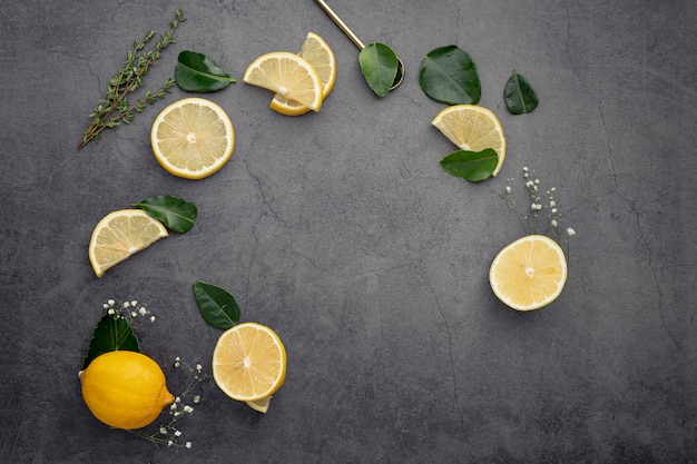 Flat lay of lemon slices with leaves