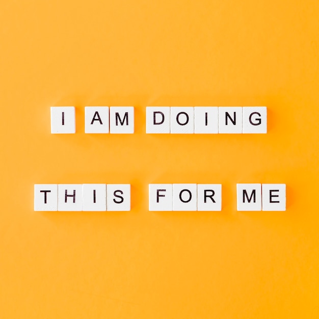 Flat lay letter cubes on yellow background