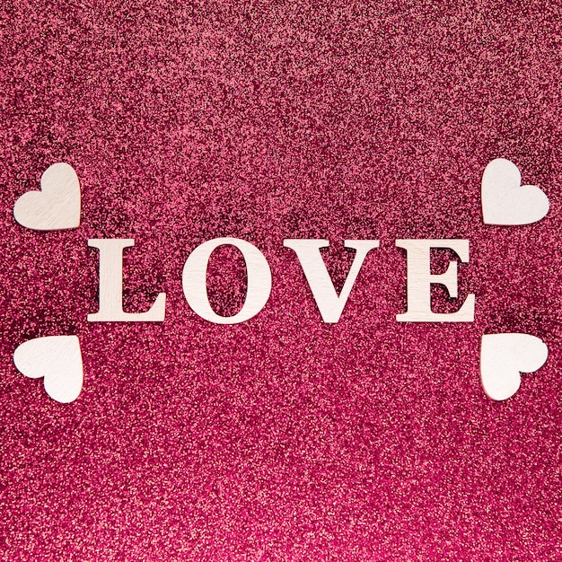 Photo flat lay of love concept on bright pink glitter sparkle backround