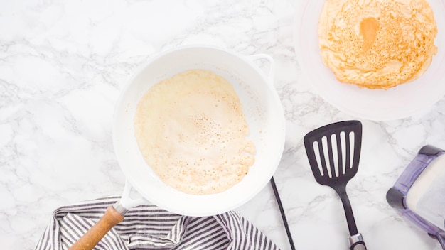 Flat lay. Making crepes in a small frying pan over medium heat.