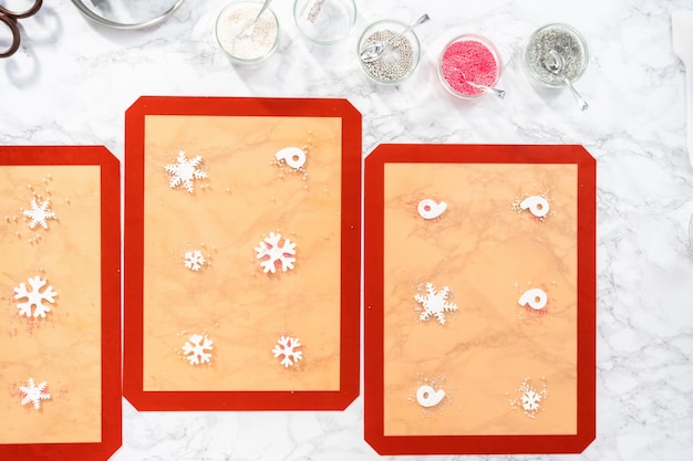 Flat lay. Making homemade berry flavor lollipops with snowflakes.