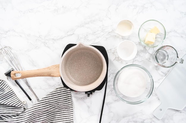 Flat lay. Making homemade caramel from scratch in a small saucepan.