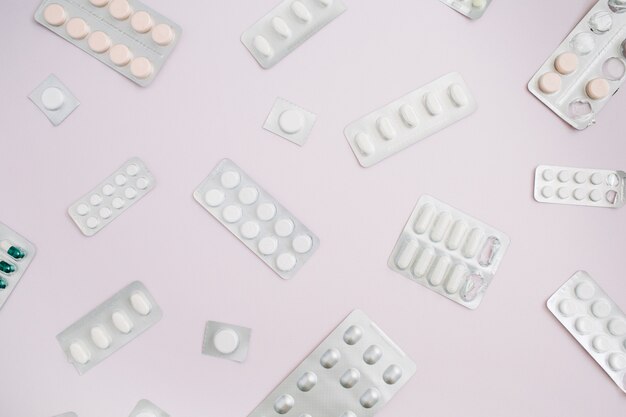 Flat lay medicine pills on pink