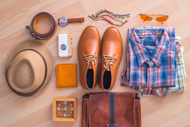 flat lay of men's casual fashion on brown wooden floor background