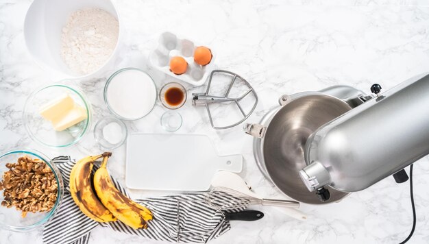 Flat lay. Mixing ingredients in kitchen mixer to bake banana nut bread.