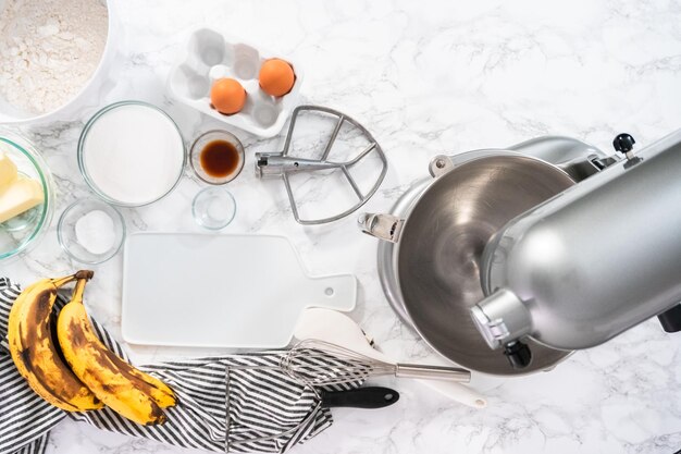 Flat lay. Mixing ingredients in kitchen mixer to bake banana nut bread.