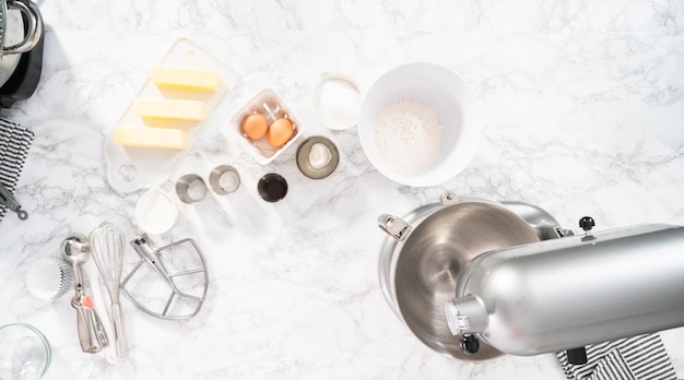 Flat lay. Mixing ingredients in standing kitchen mixer to bake vanilla cupcakes.