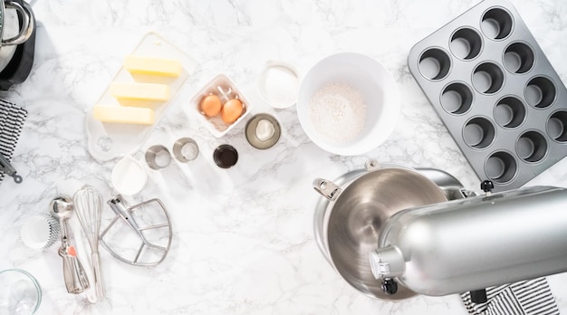 Flat lay. Mixing ingredients in standing kitchen mixer to bake vanilla cupcakes.